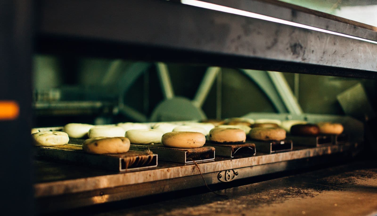 Continuous tunnel oven baking trays of product