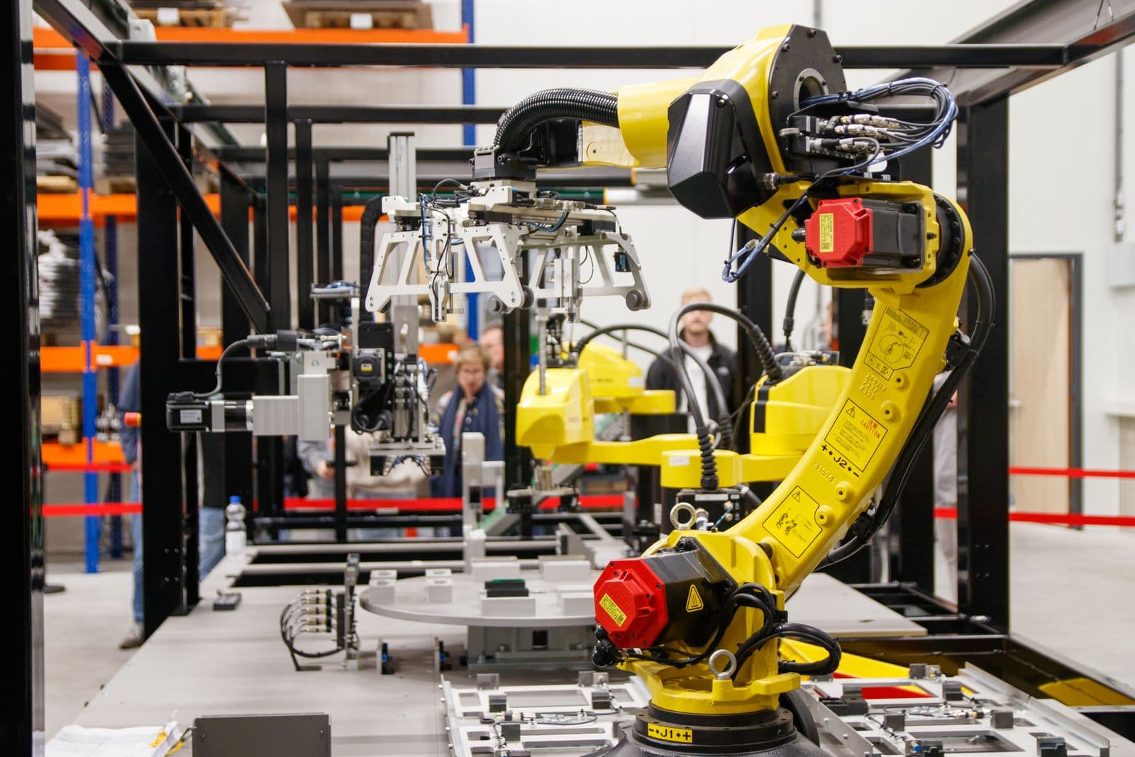 Articulated robot arms on an assembly line