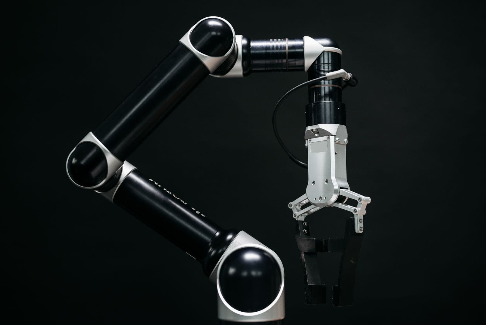 Precision robotic arm on a dark studio backdrop